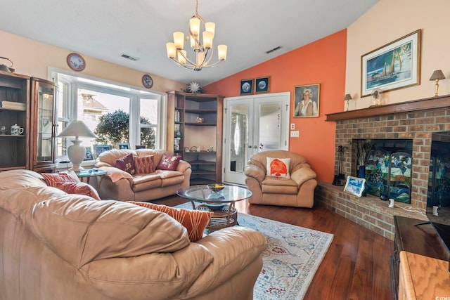 living area featuring dark wood-style floors, french doors, a fireplace, lofted ceiling, and visible vents