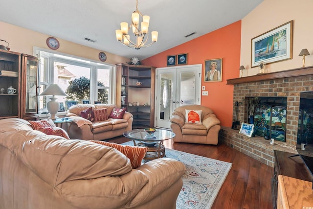 461 Spauldingwood Rd, Little River, SC 29566 - living room with vaulted ceiling, a chandelier, dark wood finished floors, french doors, and a brick fireplace