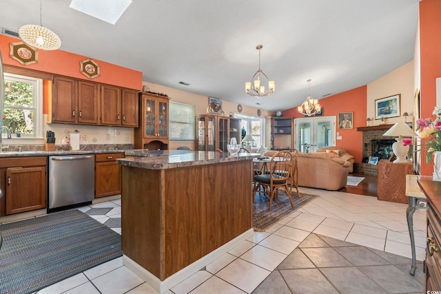 kitchen featuring a wealth of natural light, a chandelier, open floor plan, and stainless steel dishwasher