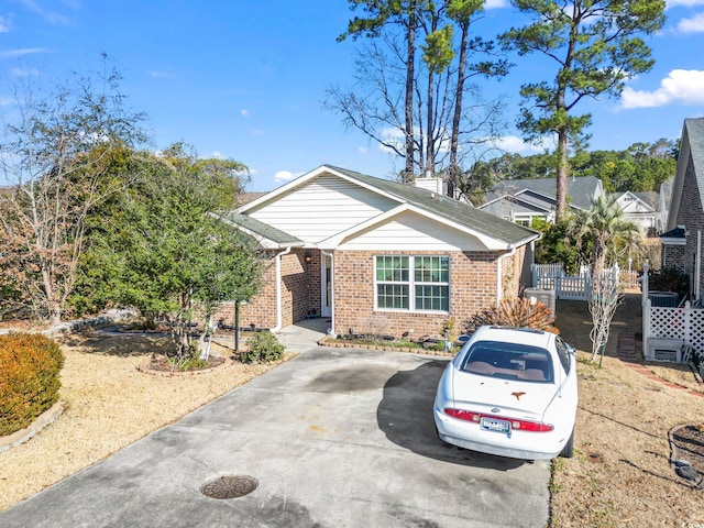 view of front of property featuring driveway and brick siding