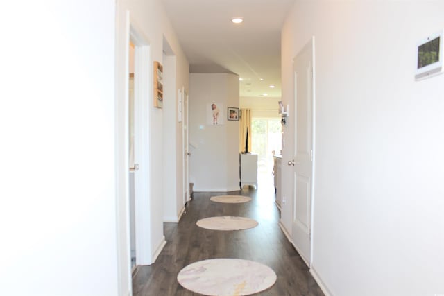 hallway with dark hardwood / wood-style floors