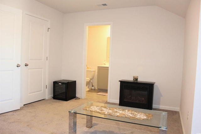 interior space featuring lofted ceiling and light colored carpet