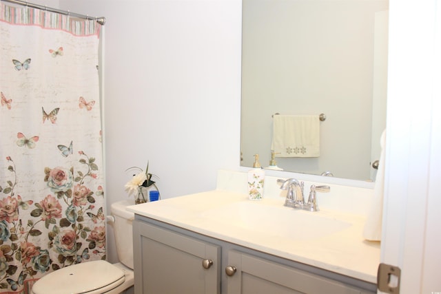 bathroom featuring vanity, toilet, and a shower with shower curtain