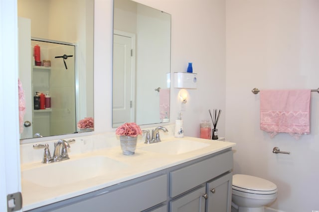 bathroom featuring vanity, a shower, and toilet