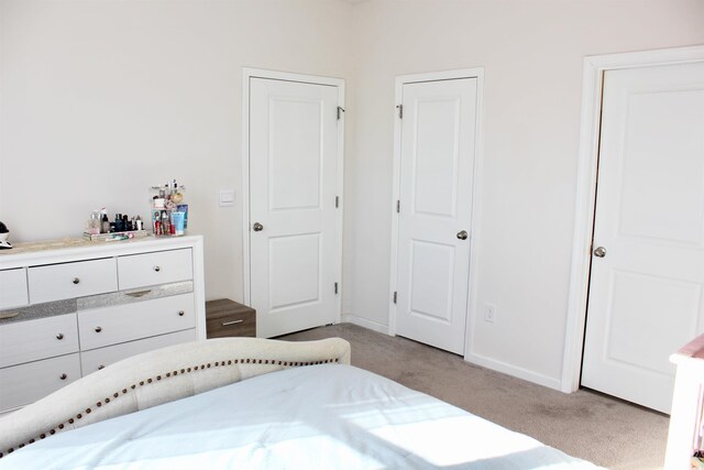 bedroom with light colored carpet