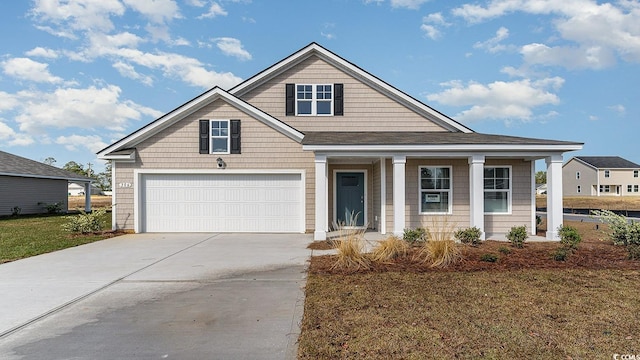 view of front of property with a garage and concrete driveway