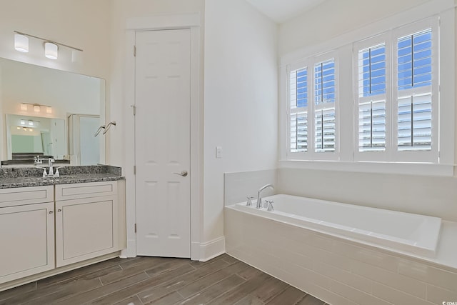 822 Farrow Pkwy, Myrtle Beach, SC 29577 - bathroom with a garden tub, vanity, wood finished floors, and a closet