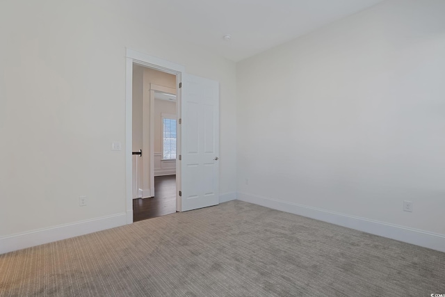 spare room with carpet floors and baseboards