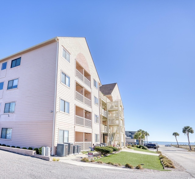 view of property with a water view and central AC