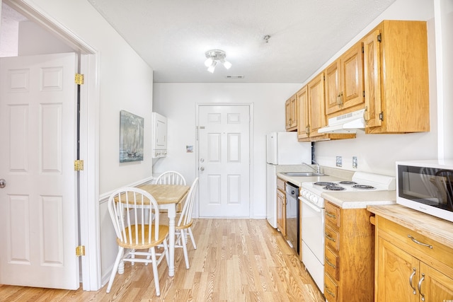 kitchen with white appliances, light hardwood / wood-style floors, and sink