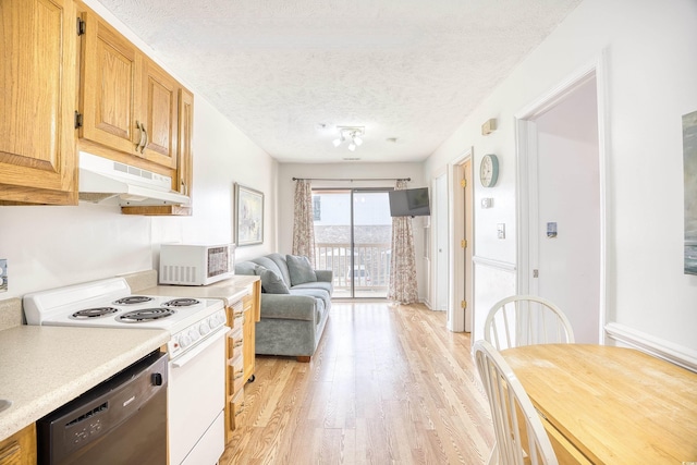 kitchen featuring a textured ceiling, white appliances, and light hardwood / wood-style floors