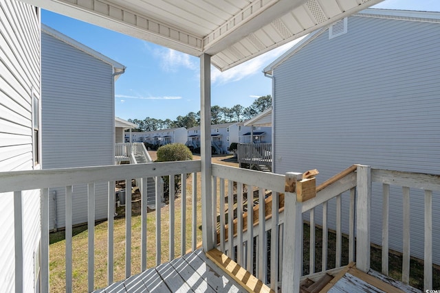 wooden deck with a lawn