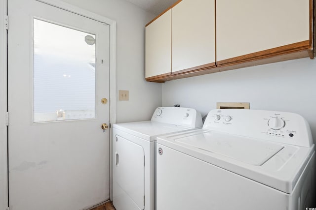 laundry room with cabinets and washing machine and clothes dryer