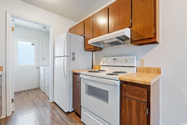 kitchen with washer and dryer, a textured ceiling, white range with electric stovetop, and light hardwood / wood-style flooring