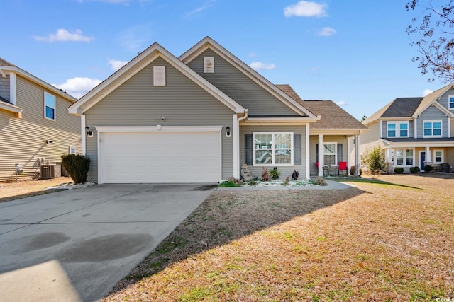 view of front of house with a garage, a front yard, and central air condition unit