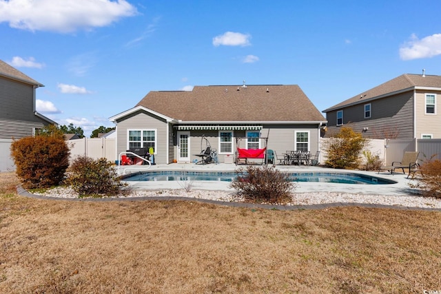 back of house with a patio, a fenced in pool, and a lawn