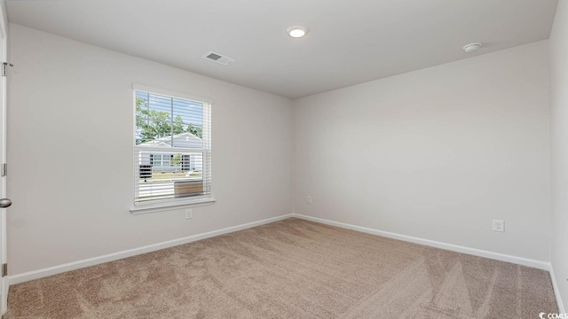 carpeted empty room with baseboards and visible vents