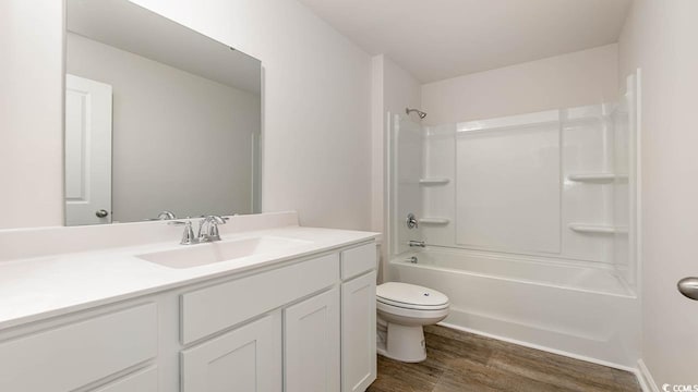 full bath with toilet, shower / bathing tub combination, wood finished floors, and vanity