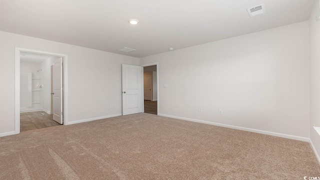 interior space featuring carpet floors, baseboards, and visible vents