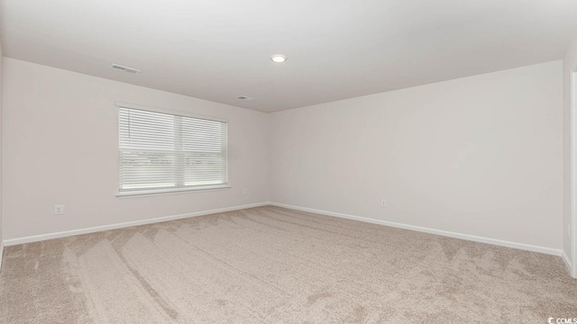 empty room with recessed lighting, carpet flooring, visible vents, and baseboards