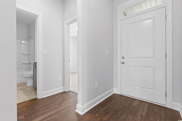 entrance foyer with dark wood-style floors and baseboards