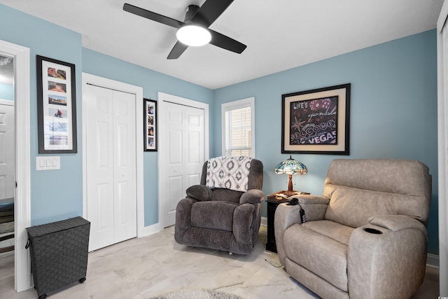 living area featuring ceiling fan