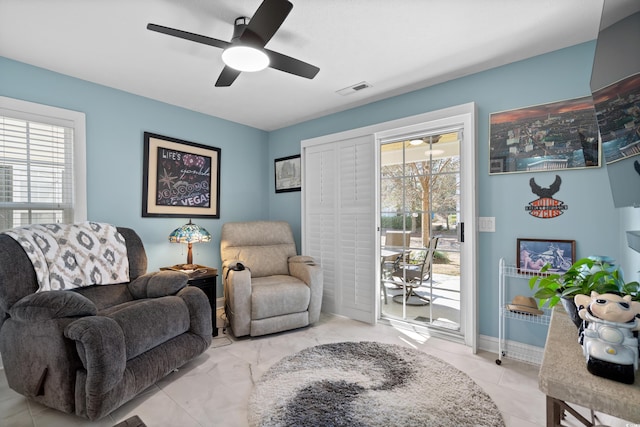 sitting room featuring a healthy amount of sunlight and ceiling fan