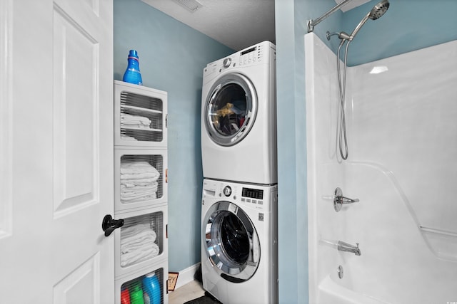 washroom with stacked washer and clothes dryer