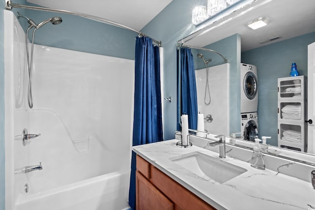 bathroom featuring vanity, shower / bath combo, and stacked washing maching and dryer