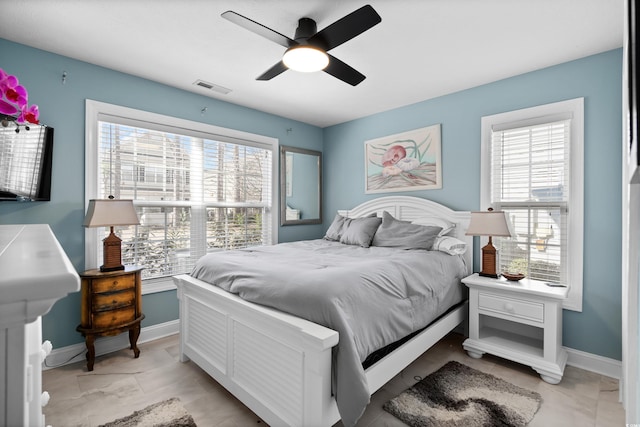 bedroom with multiple windows and ceiling fan