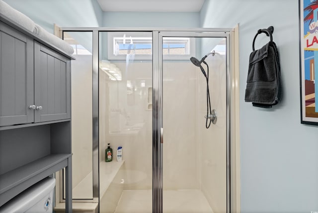 bathroom with toilet and a shower with shower door