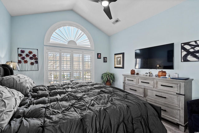 bedroom with vaulted ceiling, ceiling fan, and light wood-type flooring