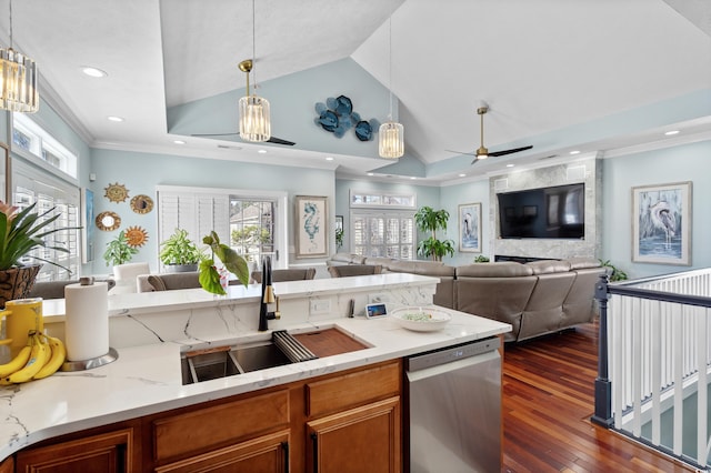 kitchen featuring stainless steel dishwasher, plenty of natural light, sink, and hanging light fixtures