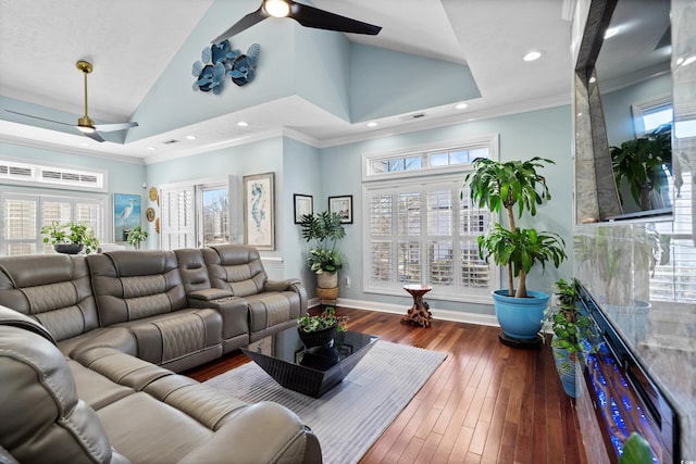 living room featuring crown molding, dark wood-type flooring, ceiling fan, high vaulted ceiling, and a healthy amount of sunlight