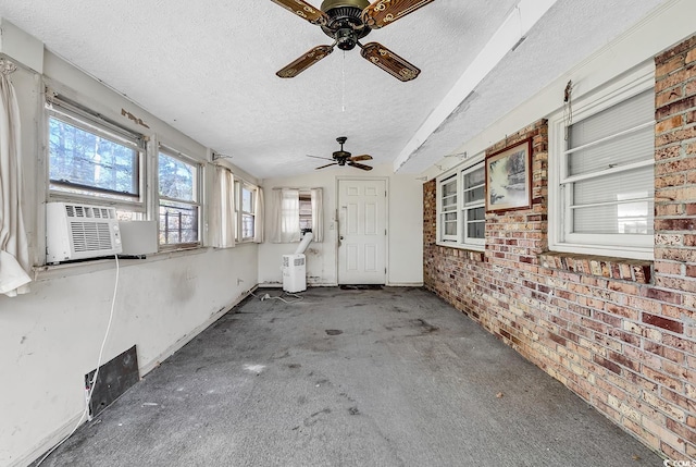 unfurnished sunroom featuring cooling unit and vaulted ceiling