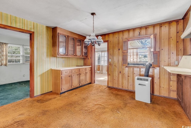 kitchen featuring dark carpet, decorative light fixtures, and an inviting chandelier