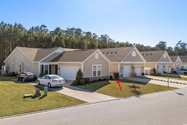 ranch-style house featuring a garage and a front lawn