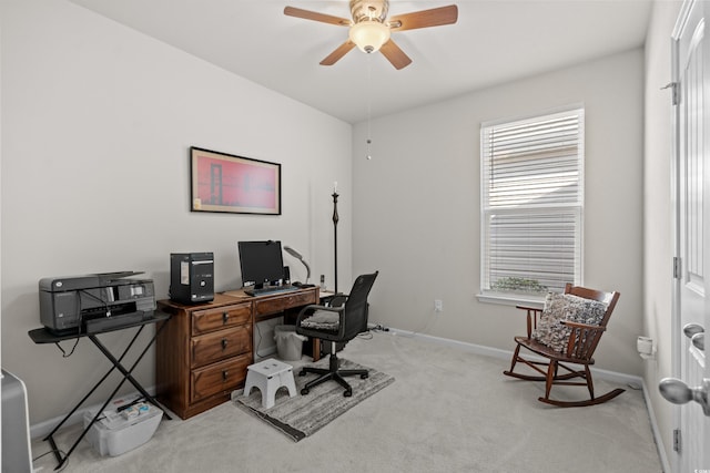 carpeted home office featuring ceiling fan