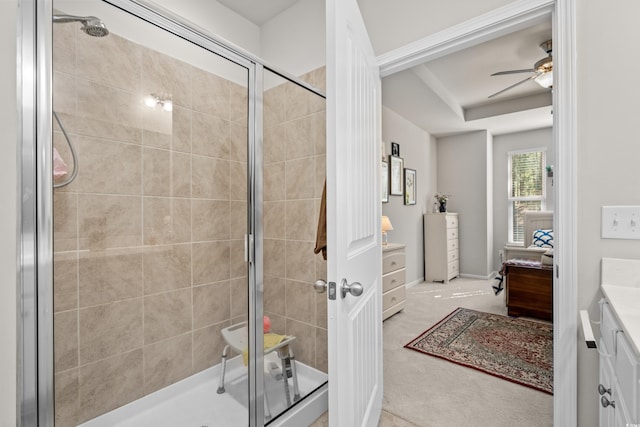 bathroom featuring ceiling fan, vanity, and a shower with shower door