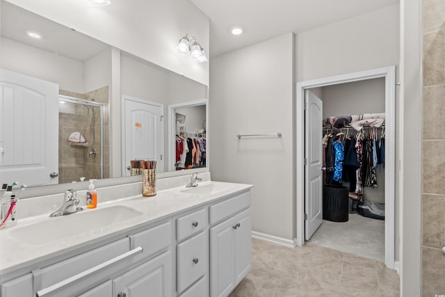 bathroom with vanity, a shower with shower door, and tile patterned floors