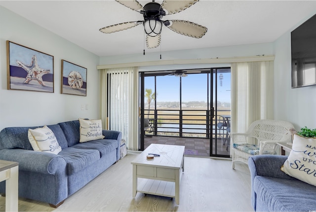 living room with ceiling fan and light hardwood / wood-style floors