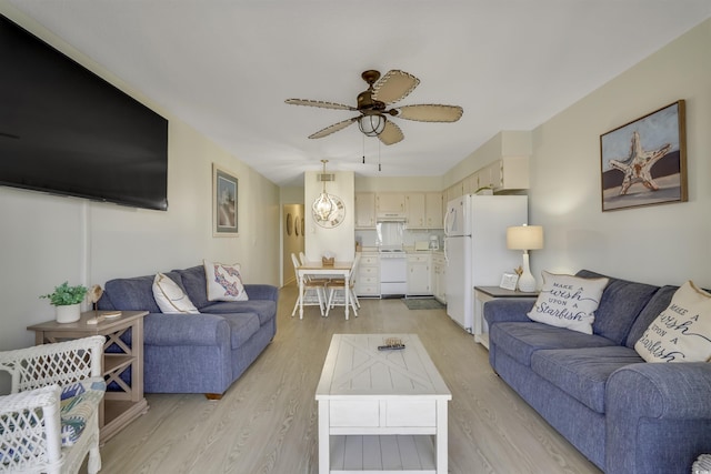 living room with ceiling fan and light hardwood / wood-style flooring