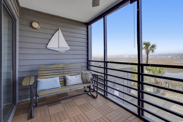 sunroom / solarium with plenty of natural light and a water view