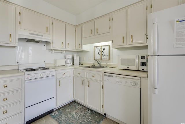 kitchen with white cabinetry, sink, and white appliances