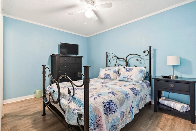 bedroom featuring crown molding, wood-type flooring, a textured ceiling, and ceiling fan