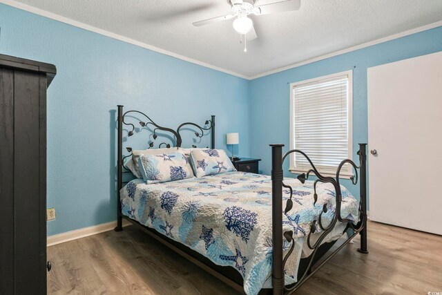 bedroom with hardwood / wood-style floors, ornamental molding, a textured ceiling, and ceiling fan