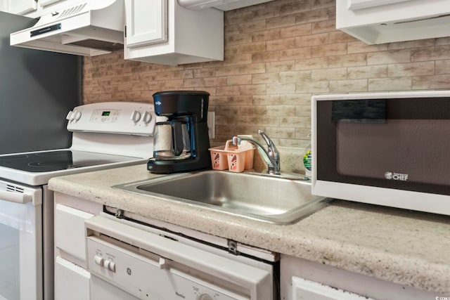 kitchen with white cabinetry, sink, white appliances, and decorative backsplash