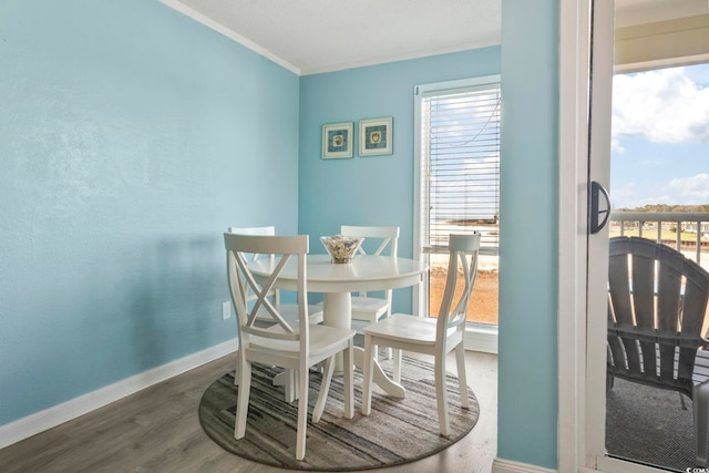 dining room featuring ornamental molding and dark hardwood / wood-style floors