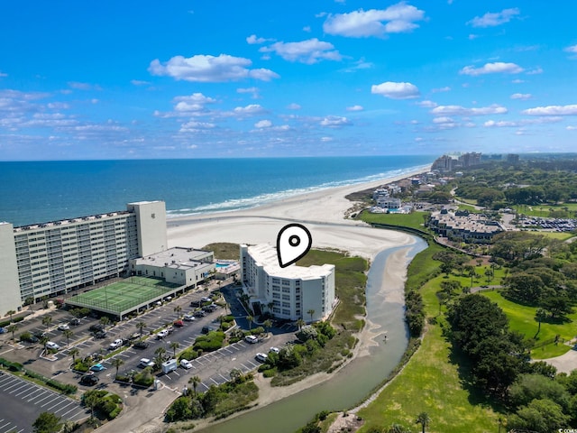 birds eye view of property with a water view and a view of the beach