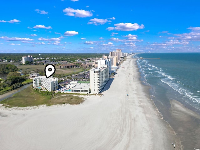 birds eye view of property featuring a water view and a beach view